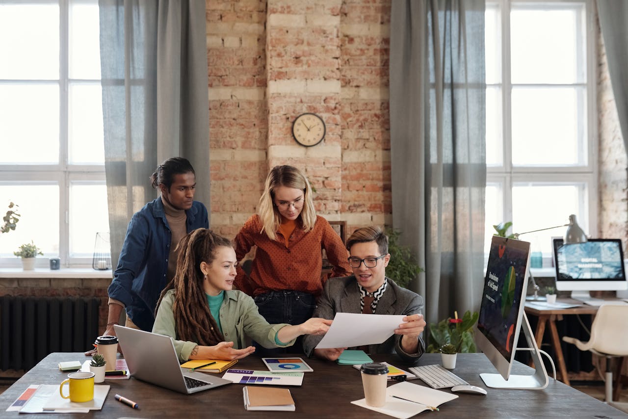 my-steps A diverse team of young professionals working on a business strategy in an urban office setting.